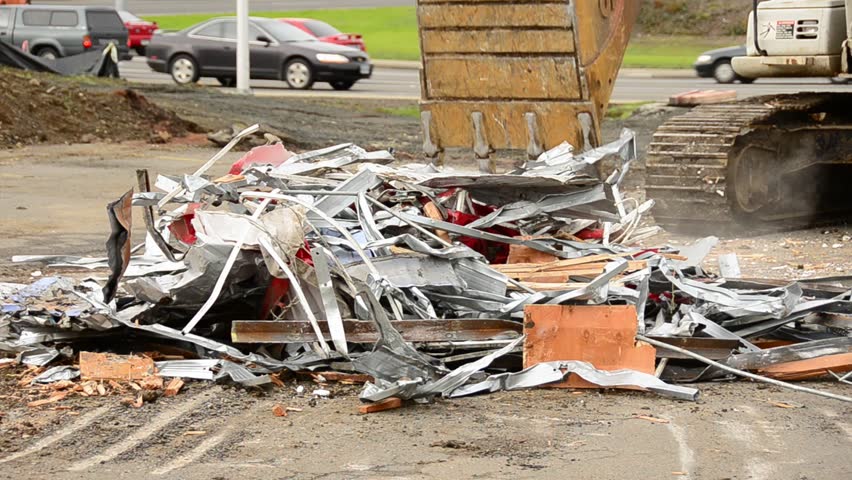 Excavator working a pile of scrap metal