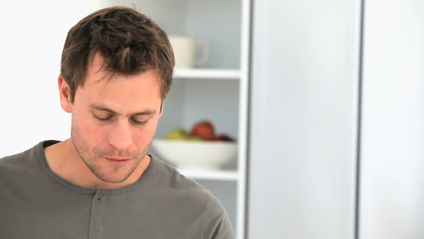 Handsome man drinking a glass of milk