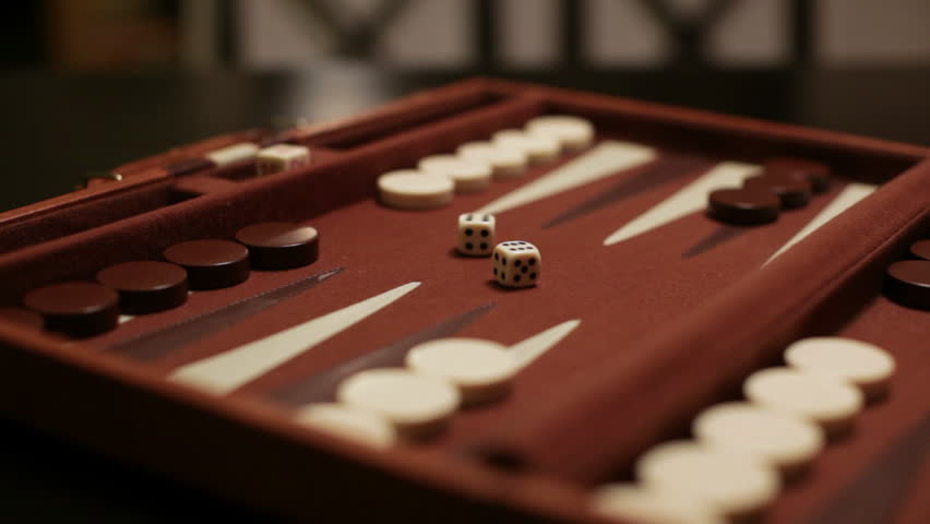 a backgammon player makes his move after rolling double sixes.