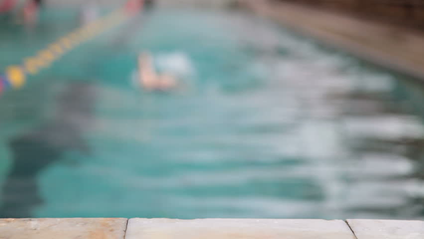 child competing in a swimming race 