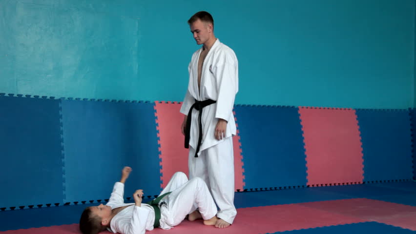 Boy learning from his karate instructor