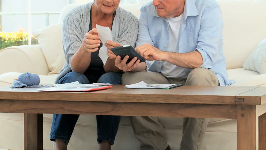 Mature couple calculating their bills