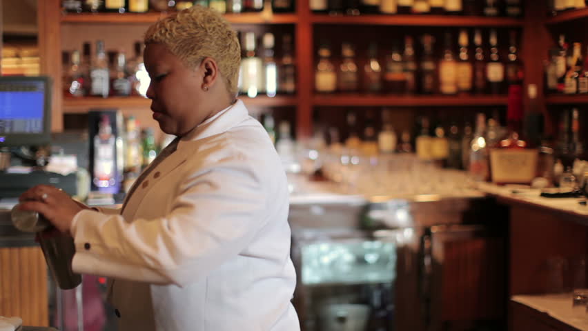 A series of model released clips featuring a female cocktail waiter in a classic looking cocktail bar in barcelona, Spain