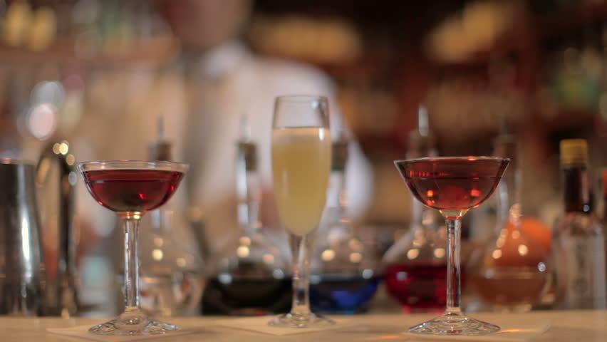 A series of model released clips featuring a female cocktail waiter in a classic looking cocktail bar in barcelona, Spain