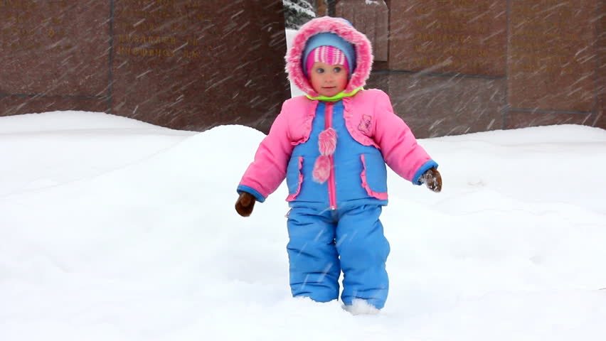 baby girl walking in winter park