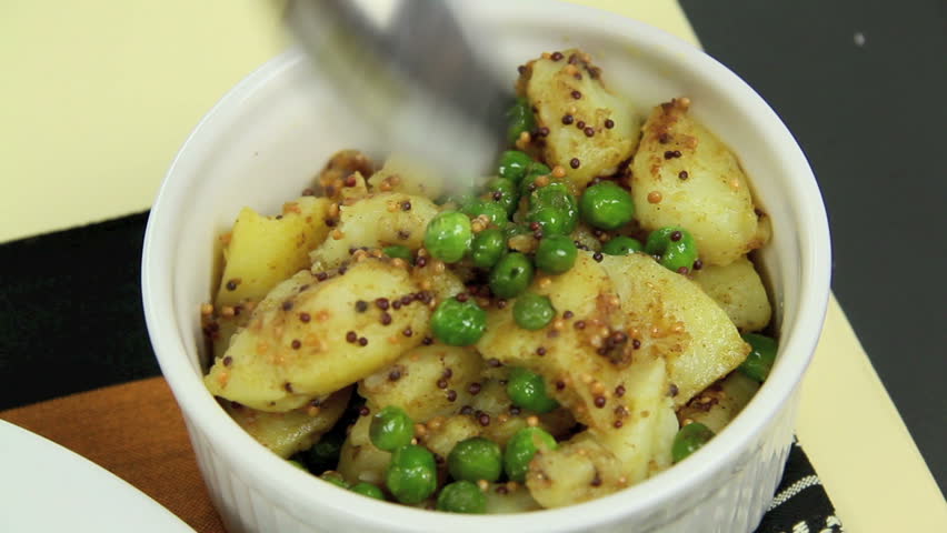 Putting delicious spicy Indian curry and potatoes into a crispy pappadum. 