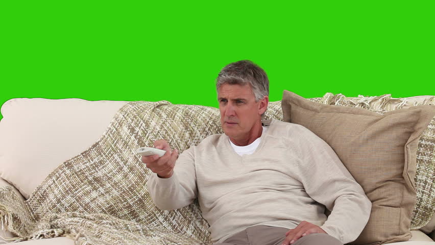 Chromakey footage of a retired man glad to watch TV