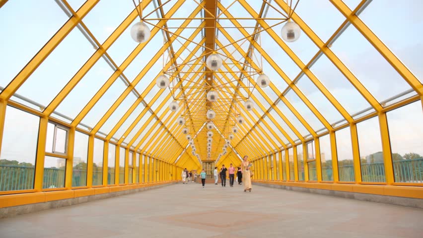 MOSCOW - MAY 15: People walk on the Andreyevsky bridge on May 15, 2010 in Moscow, Russia. Andreyevsky Bridge refers to a historical bridge demolished in 1998 and three existing bridges across Moskva River, located between Luzhniki and Gorky Park in Moscow