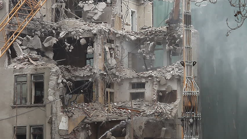 Demolition. Dust, debris and water. General view, establishing shot. 