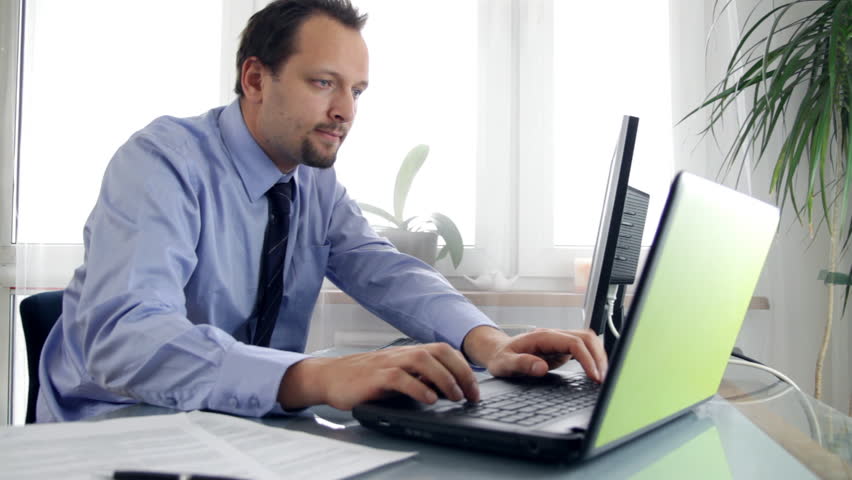 Businessman receiving phone call during work and checking documents