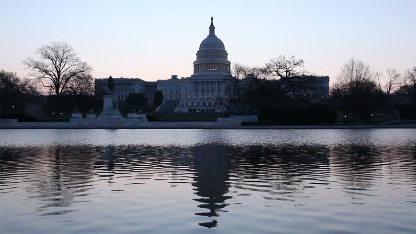 Dawn at the Capitol as the dome is reflected in the reflecting pool in front of the Senate building