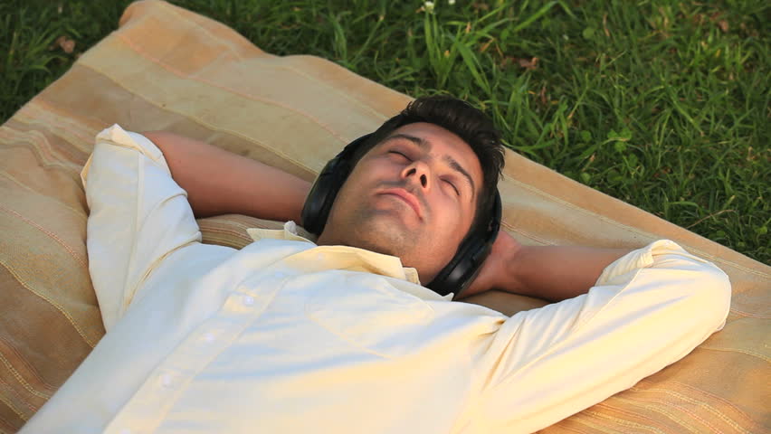Man taking a nap while listening to music with headphones