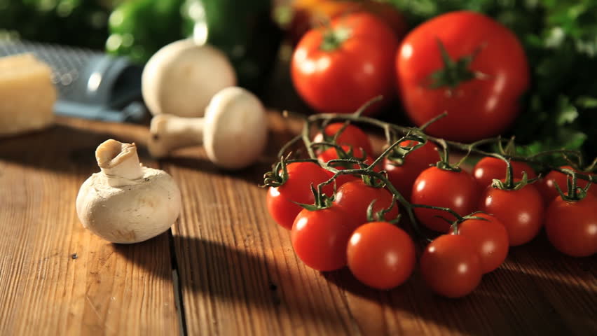 panning through ingredients to fresh made pizza coming out from oven