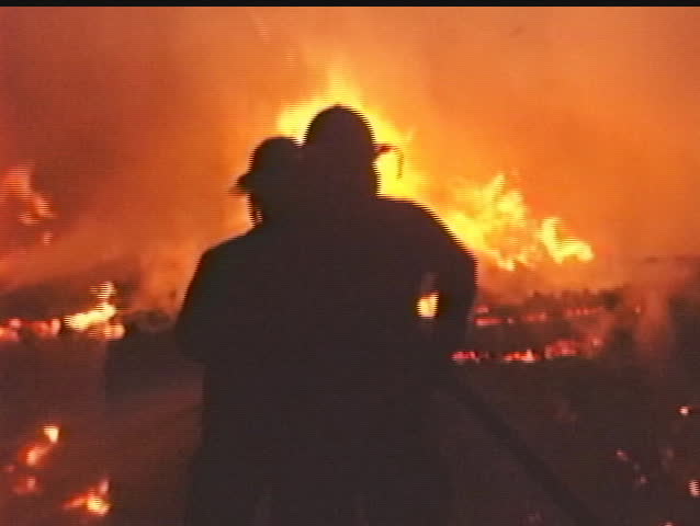 Firefighters Silhouetted by fire