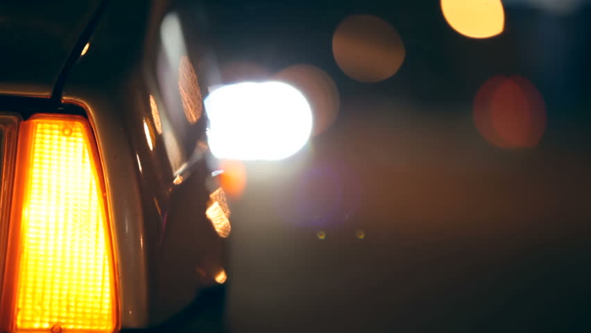 Flashing Car Hazard Lights  on urban road at night