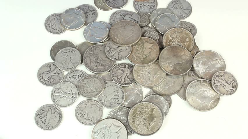Hands sort through old, silver coins. 1080p