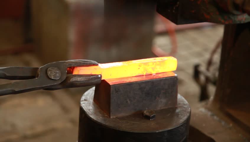 Red hot iron lingot on a press machine