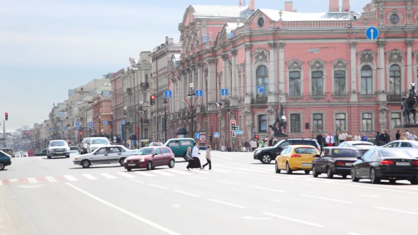 movement of vehicles pedestrians at crossing during day in Petersburg