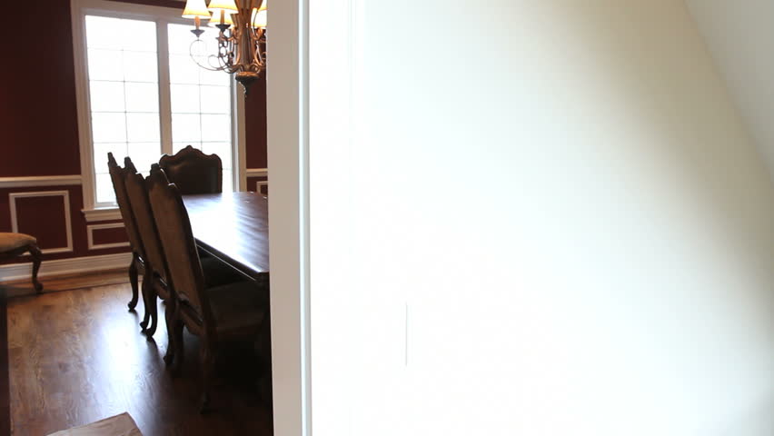 Moving dolly shot of a dining room with table and chairs in a luxury house