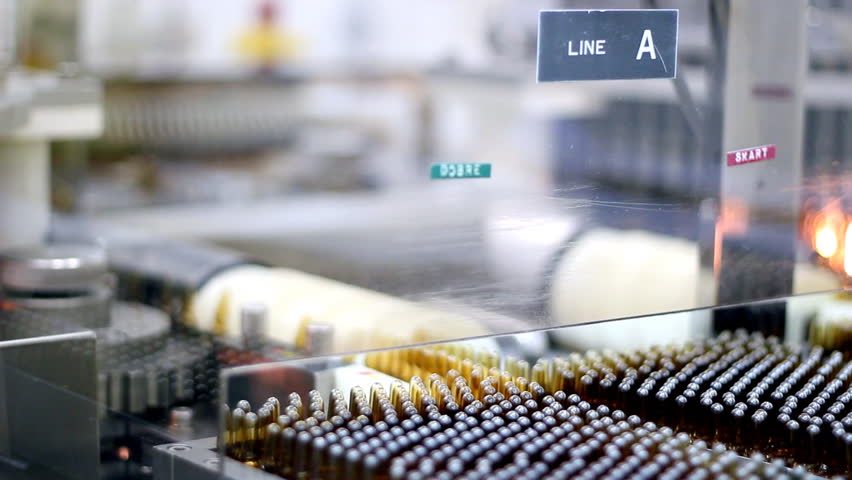 Transfer of ampules in automatic optical inspection machine. Rack Focus.  HD 1080i. 