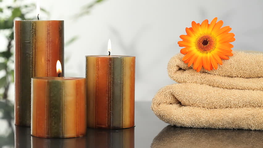 Close-up on candles, towels and sunflower in a Spa center