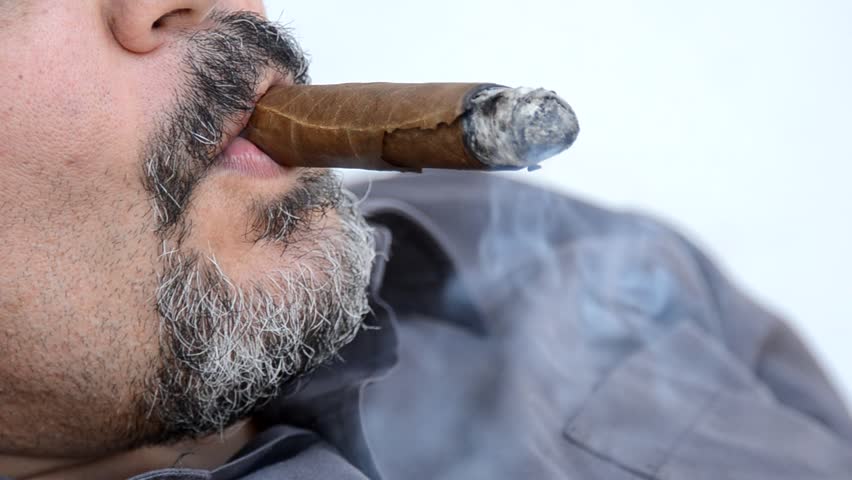 man smoking cigar - closeup