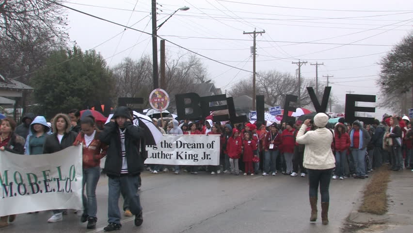 Video of the largest Martin Luther King MLK March in the USA in San Antonio, Texas. Multi ethnic support of equal rights. Misty rainy day in January. We Believe sign.