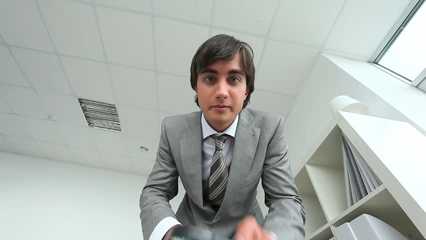 Curious man looking at something through magnifying glass
