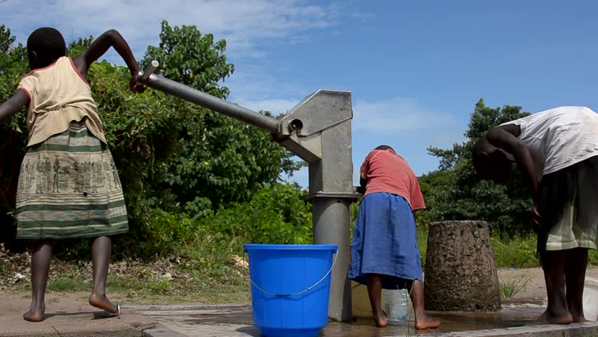 SALIMA, MALAWI - APRIL 10: Children pump drinking water from a well, April 10, 2011, Salima, Malawi. In rural Malawi, access to sanitation is considerably lower with only 15% - 30% of the rural population having access to a latrine. 