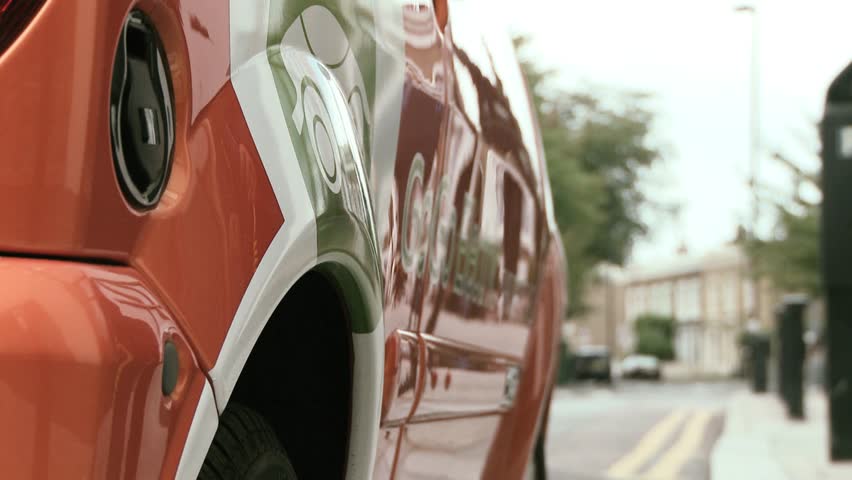 Plugging in power cord to an electric car 