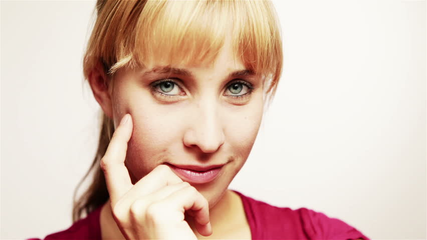 Happy young woman thinking and smiling