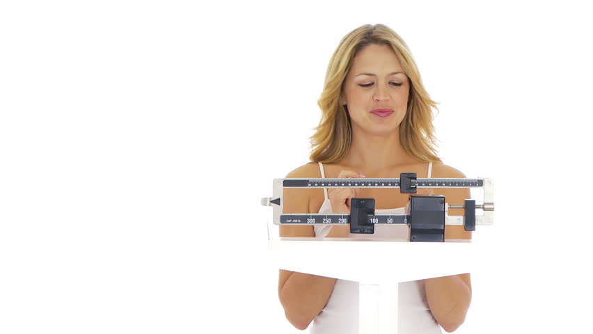 Young woman on scale happy about her weight