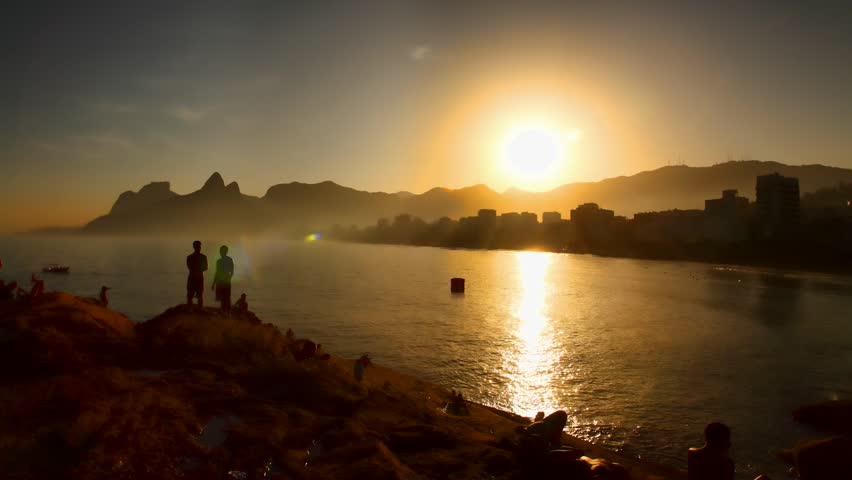 RIO DE JANEIRO, BRAZIL - JUNE 26: Tourists and locals watch sunset at Ipanema Beach, Rio de Janeiro, Brazil June 26 2011. Ipanema is the second most affluent neighborhood in Rio after Leblon, 