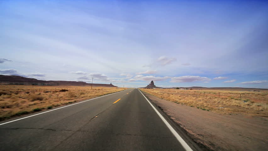 Driving the long straight road through the desert to Monument Valley, Arizona