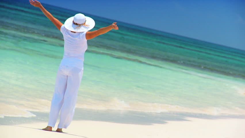 Elegant young female reveling in achieving her fantasy of a luxury island vacation