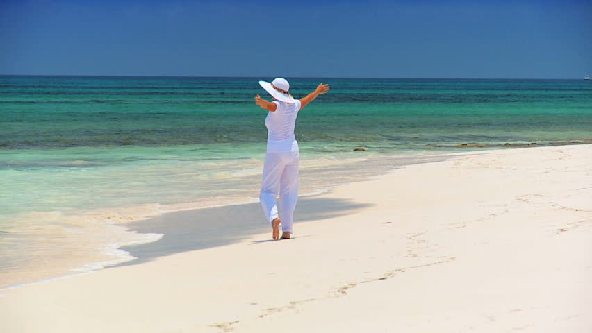 Elegant young female reveling in achieving her fantasy of a luxury island vacation