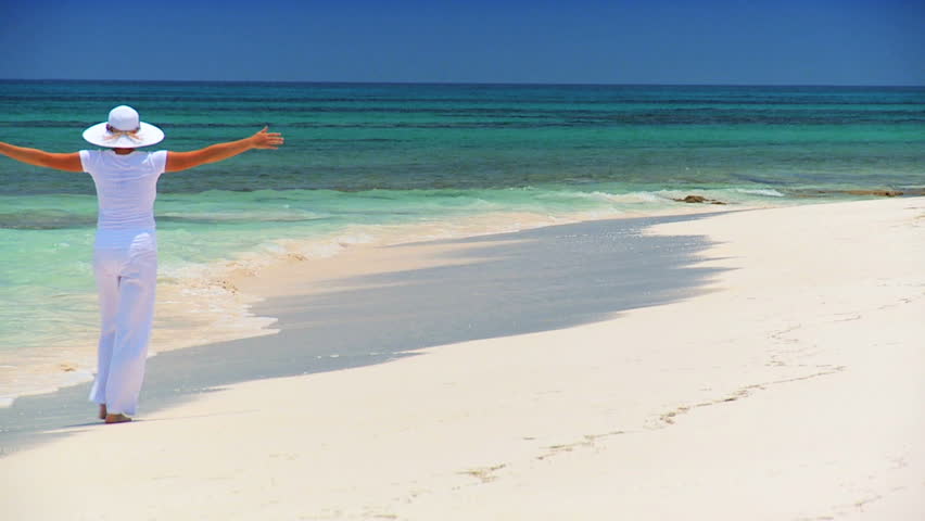 Elegant young female reveling in achieving her fantasy of a luxury island vacation