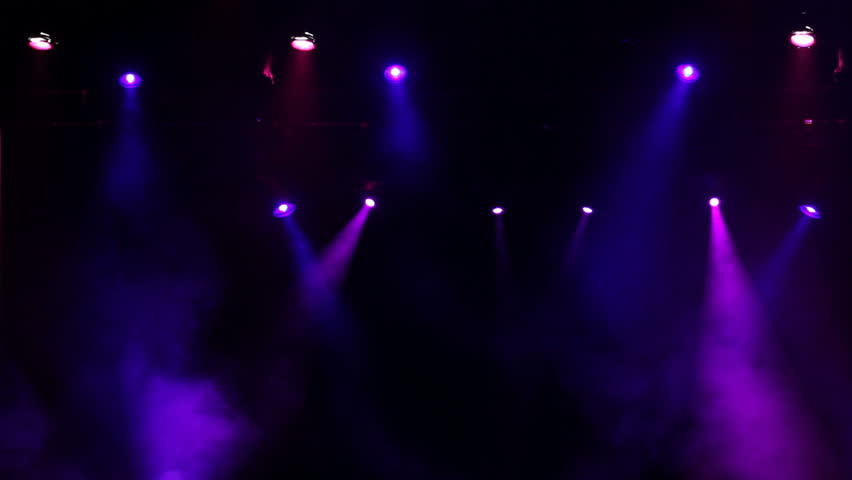 An extreme wide shot of a real concert stage with lights and smoke. Could be used as a background or as an overlay.