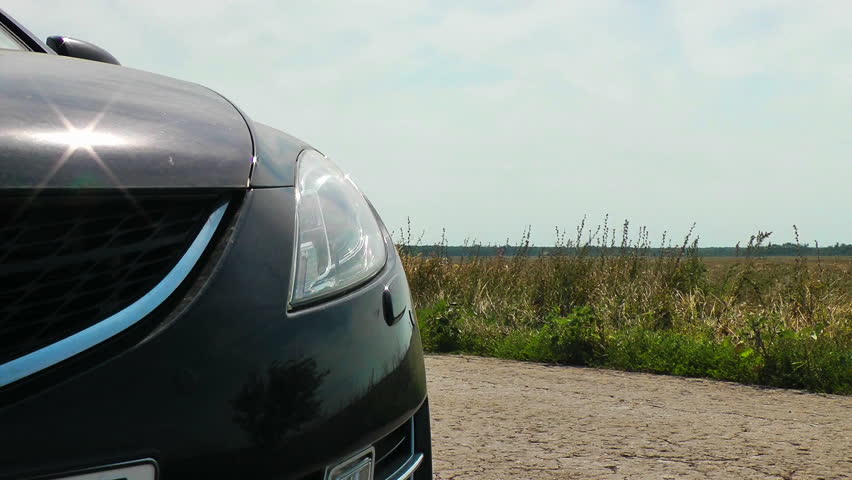Broken down car with alarm signaling on a country road