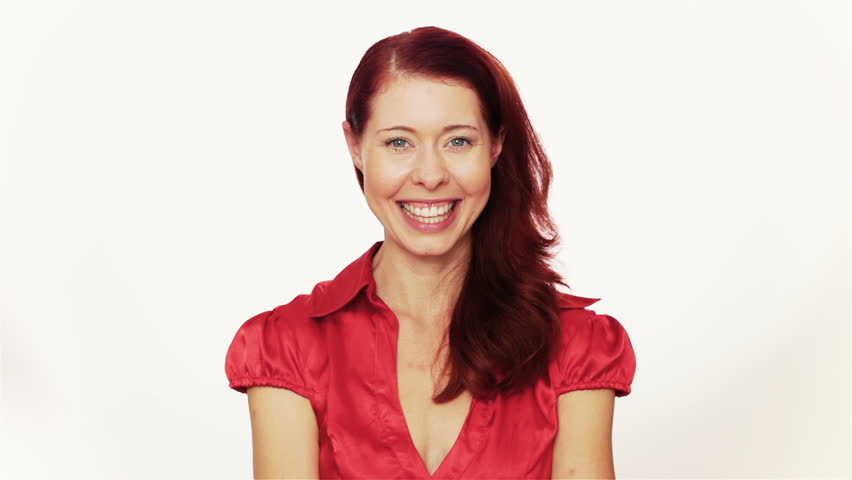 Happy redhaired woman turning oversized jigsaw puzzle piece