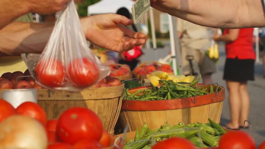Food being purchased at Farmer's Market.