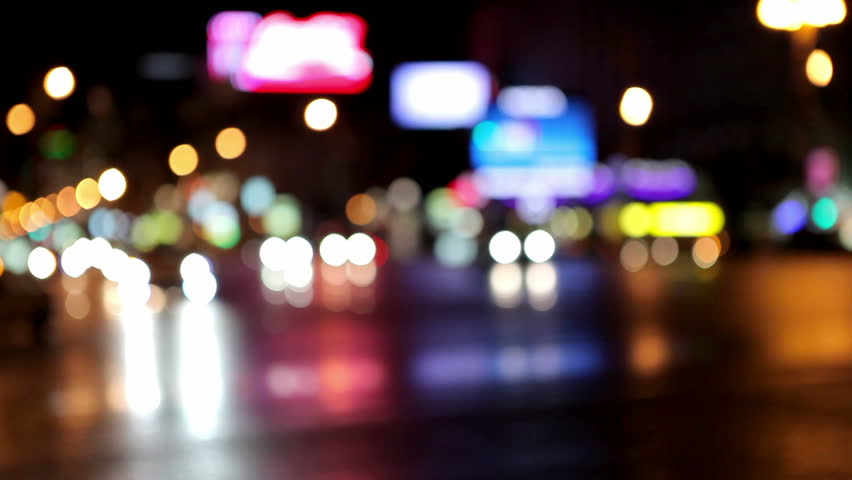police car with flares drives through the city center night