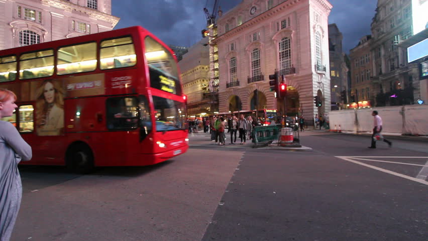 LONDON, UK - JULY 25: Public buses and cars drive on Piccadilly Circus in the evening on July 25, 2011 in London, UK. Piccadilly Circus is the centre of a large shopping and tourist area in London.