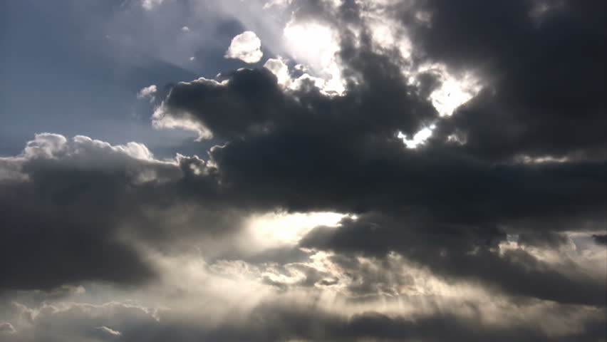 Time lapse of the sun shining through the clouds.