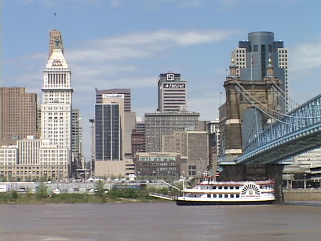 CINCINNATI, OH - CIRCA 2010: A riverboat passes under a bridge on the Ohio River circa 2010 in Cincinnati, OH.