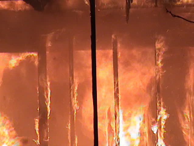 Flames engulfing the inside of a structure.