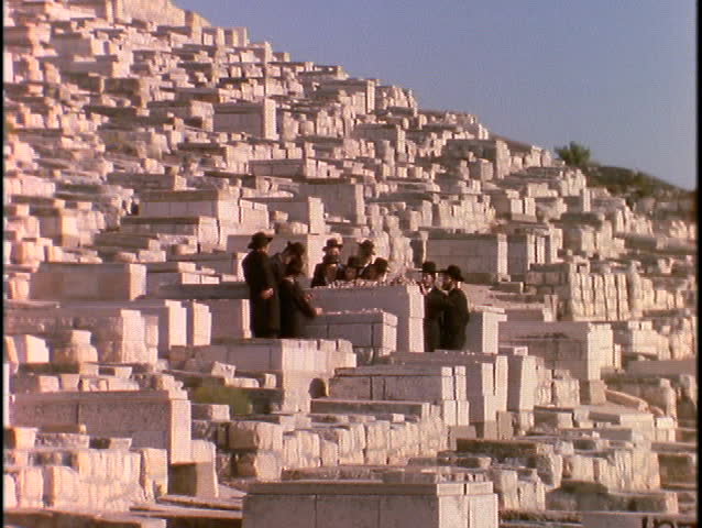Orthodox Jews stand in a cemetery at the Mount of Olives, Jerusalem.