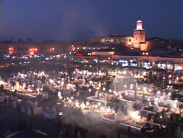 Smoke rises from food stalls at a night-time market in Marrakesh Morocco.