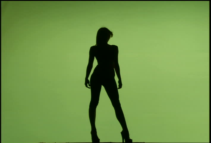 A silhouetted woman dancing against green background