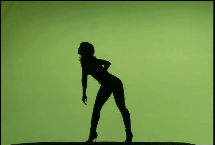 A woman's silhouette dancing against green background